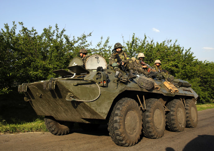 Ukrainian paratroopers ride atop an APC in the village of Starovarvarovka, southwest of the eastern Ukrainian town of Slavyansk May 15, 2014. (Reuters/Yannis Behrakis)